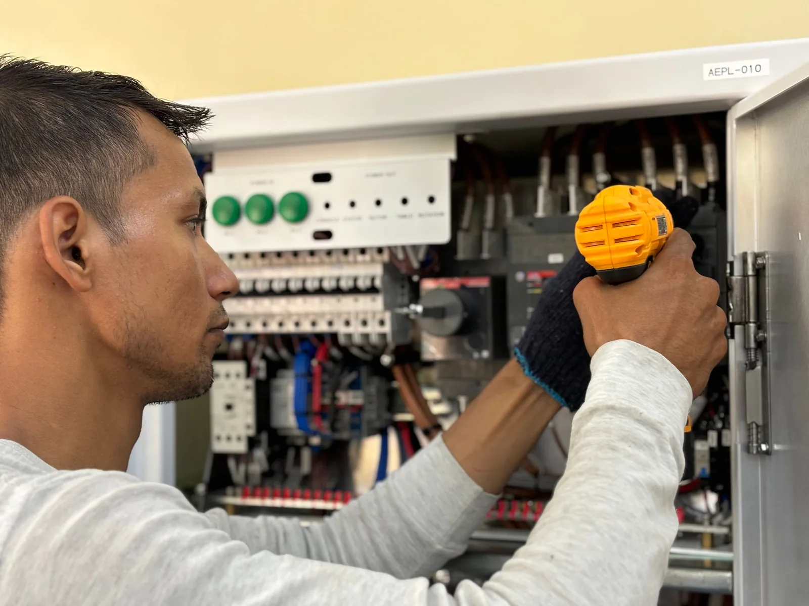 An electrician working on a commercial control panel, for subpanel installation in Oklahoma City