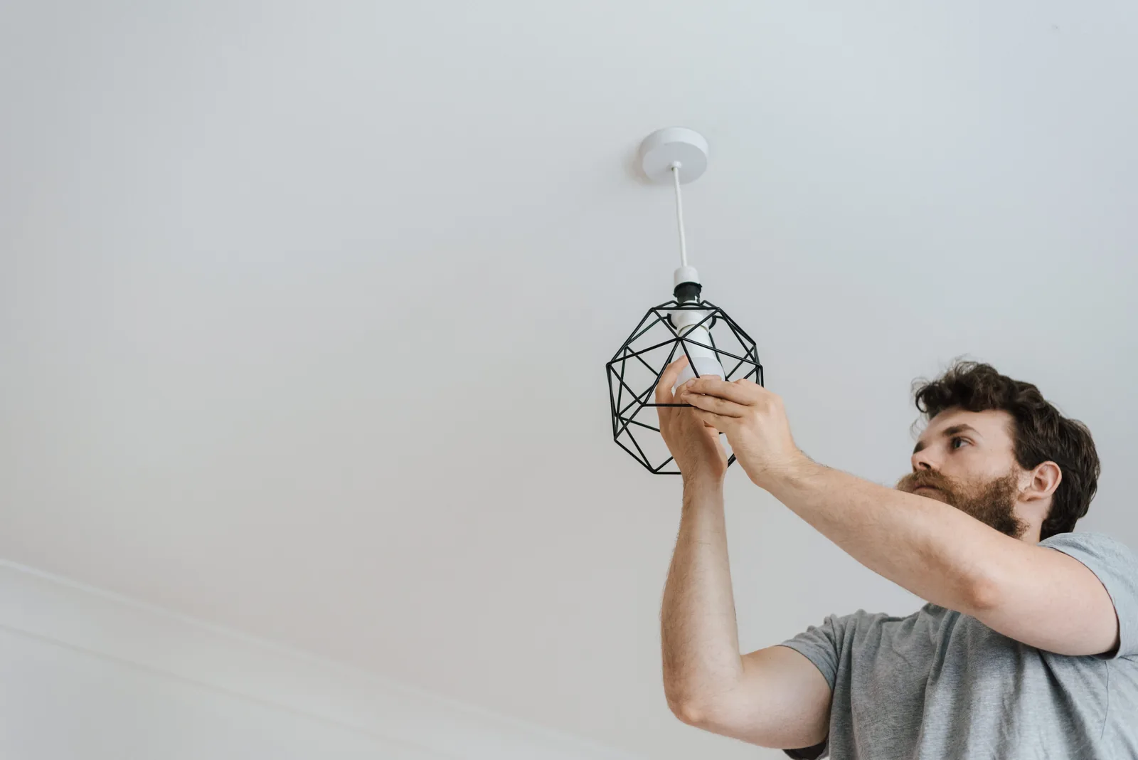 Fitting a lamp into a pendant fixture, for ceiling fan installation in Oklahoma City